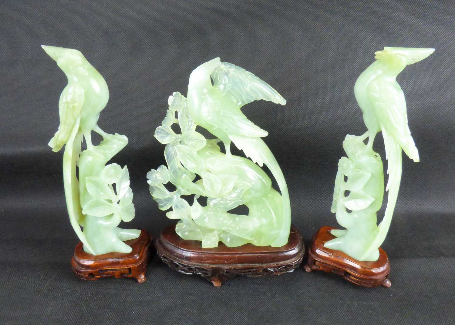 Lot 649 - A pair of Oriental jade-style exotic birds