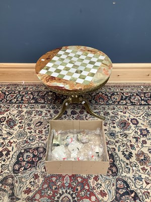 Lot 2098 - An onyx topped chess table with gilt brass...