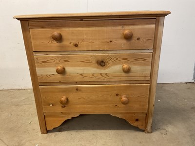 Lot 602 - A small pine chest of three long drawers,...