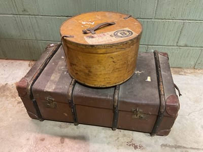 Lot 148 - A large strap bound trunk and a plywood hat...