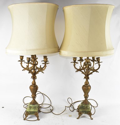 Lot 90 - A pair of gilt spelter and onyx table lamps,...