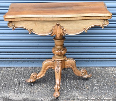 Lot 35 - A Victorian walnut card table with fold over...