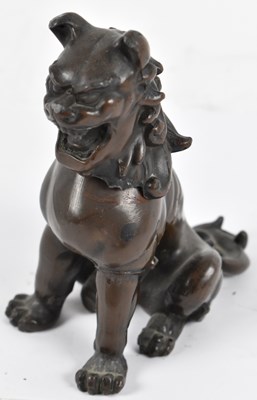 Lot 573 - A Chinese bronzed metal figure of a Dog of Fo,...