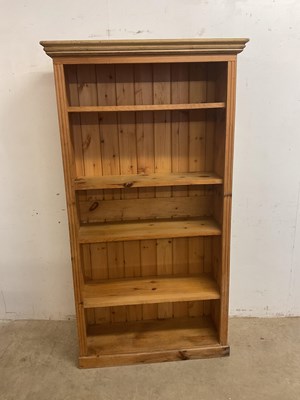 Lot 554 - A large pine open shelf book case, height...
