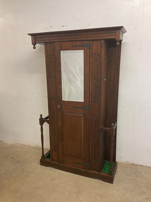 Lot 595 - An oak mirrored hall cupboard, flanked to each...