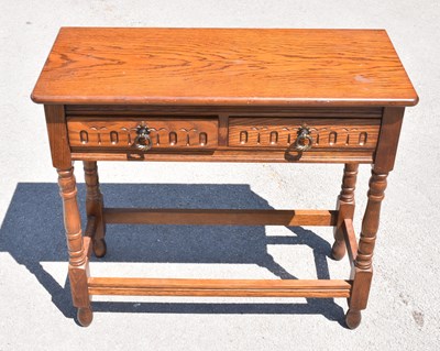 Lot 2587 - A Priory style oak two drawer side table on...