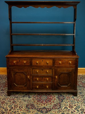 Lot 2535 - An 18th century oak dresser with three drawers...