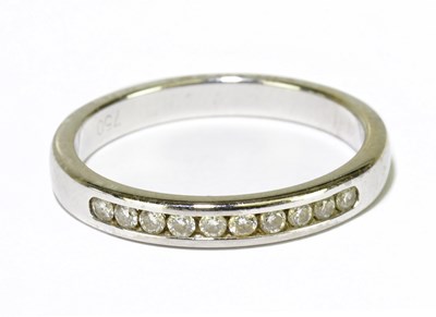 Lot 97 - An 18ct white gold and diamond channel set...