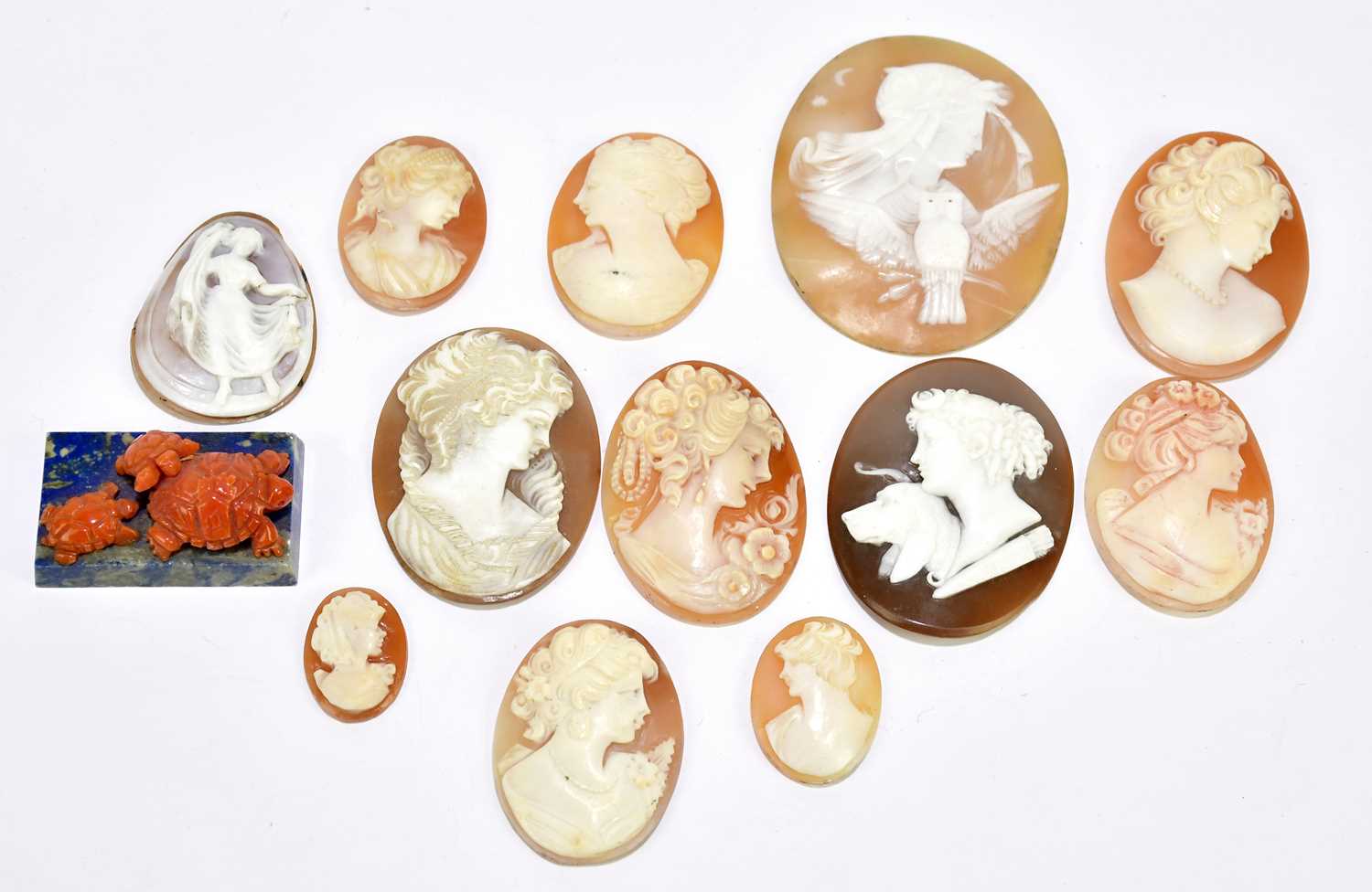 Lot 392 - A group of loose oval cameos, coral, tortoise,...