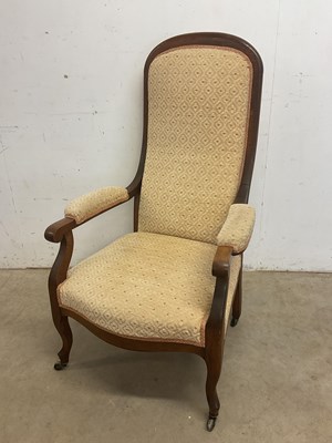 Lot 655 - An upholstered oak framed armchair.