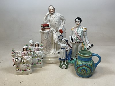 Lot 184 - A group of Staffordshire flat back figures,...