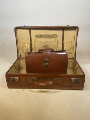 Lot 143 - A vintage leather suitcase and a briefcase (2)