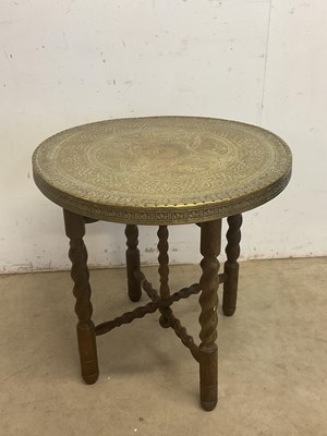 Lot 652 - A Benares type engraved brass tray on oak...
