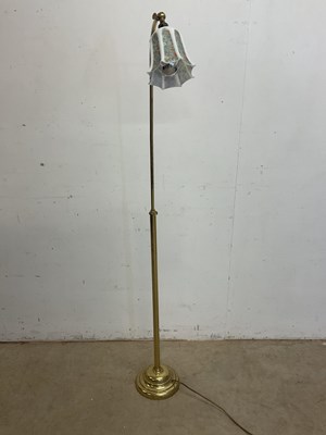 Lot 498 - An adjustable brass floor lamp and milk glass...