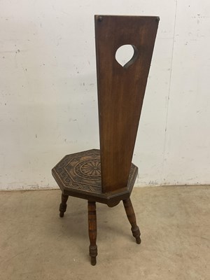 Lot 657 - A carved oak spinning chair with shaped seat...