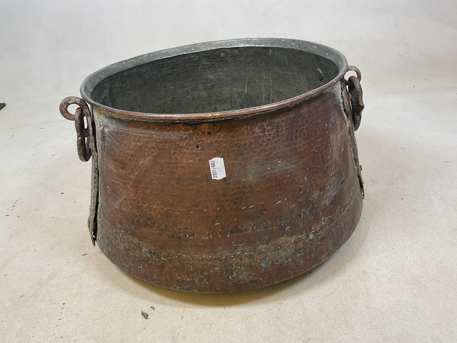 Lot 156 - A beaten copper tapering circular vessel with...