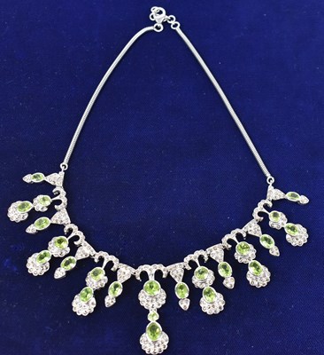 Lot 671 - An Indian white metal diamond and green...