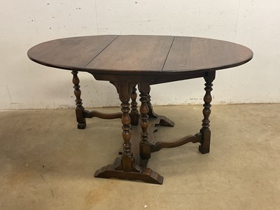 Lot 640 - A reproduction oak gateleg drop-leaf table,...