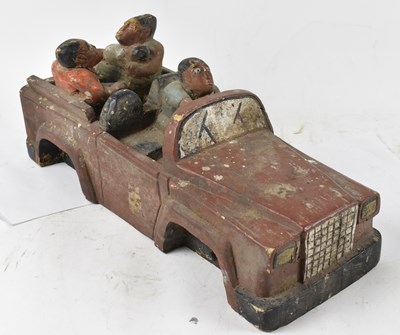 Lot 240 - A primitive carved and painted wooden model of...