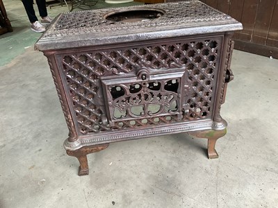 Lot 512 - A circa 1900 French cast iron stove with...