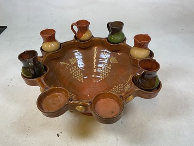 Lot 176 - A treacle glazed stoneware punch bowl set with...