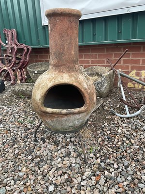 Lot 509 - A terracotta chiminea on stand.