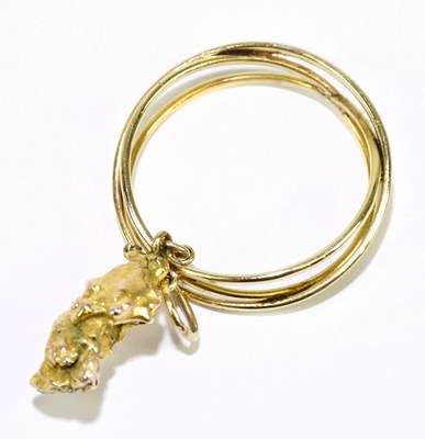 Lot 265 - A yellow metal nugget set within a pierced...