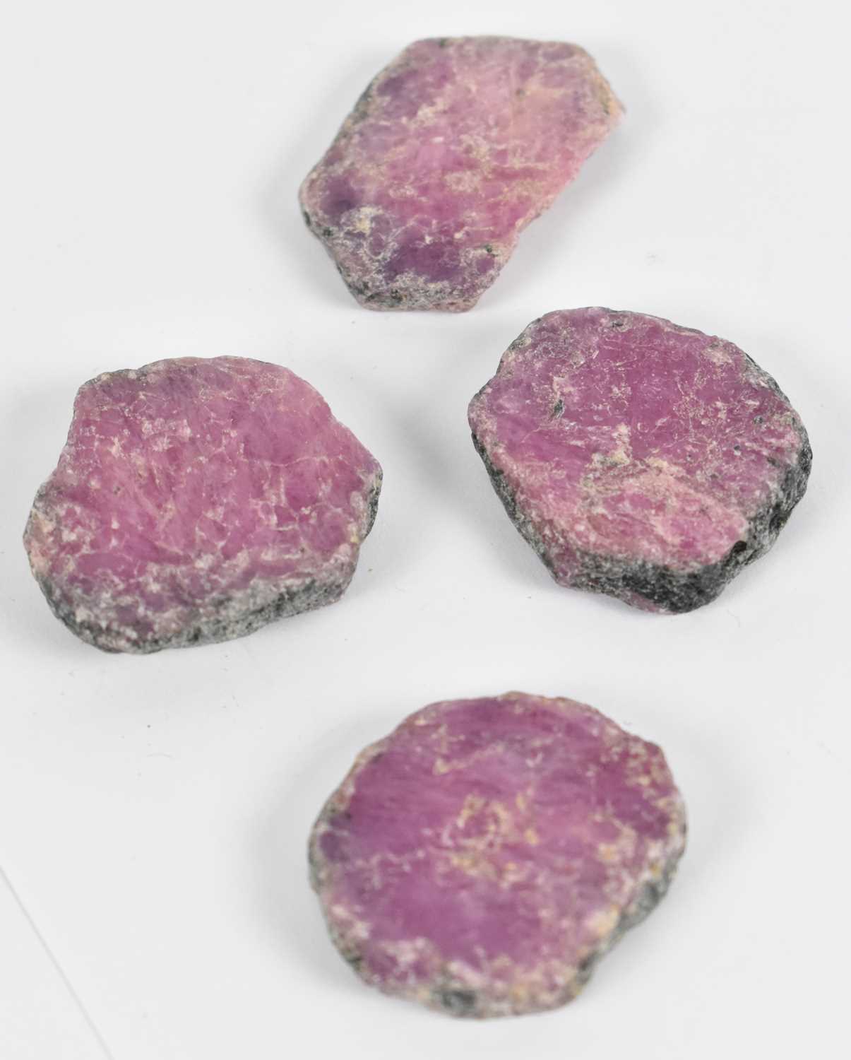 Lot 623 - Four slices of unpolished ruby.