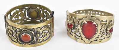 Lot 791 - Two Eastern white metal stone set bangles.