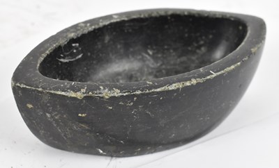 Lot 210 - An Eastern black stone shaped oval bowl,...