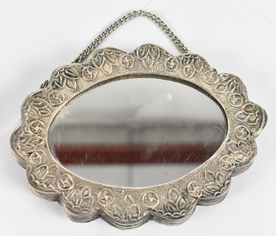 Lot 633 - An Eastern 900 grade silver shaped oval mirror,...