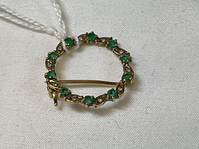 Lot 385 - A 9ct yellow gold diamond and emerald openwork...