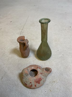 Lot 33 - A Roman green tinted glass teardrop vase,...