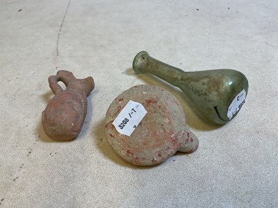 Lot 33 - A Roman green tinted glass teardrop vase,...