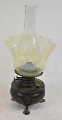 Lot 93 - An early 20th century oil lamp with Vaseline...