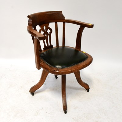 Lot 57 - An oak office captain's swivel chair with...