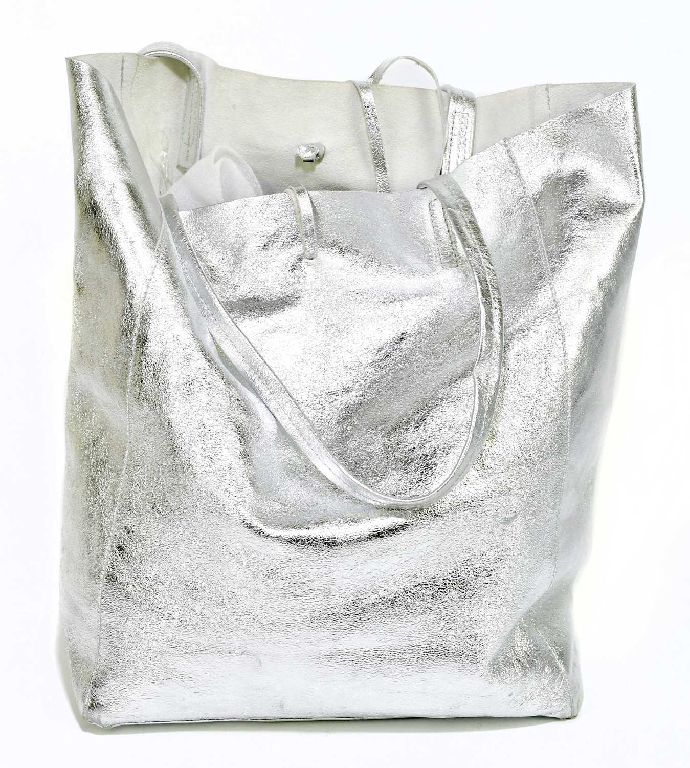 Lot 718 - A silver leather large tote bag with two top D-...