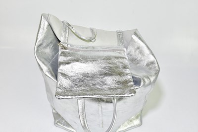 Lot 718 - A silver leather large tote bag with two top D-...