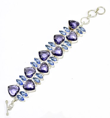 Lot 201 - A contemporary silver bracelet set with blue...