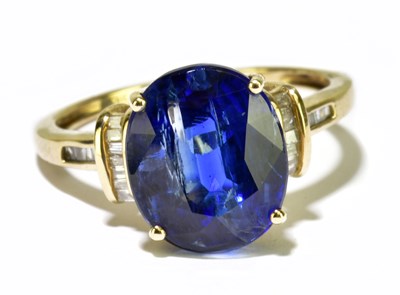 Lot 134 - A 9ct yellow gold and blue spinel dress ring,...