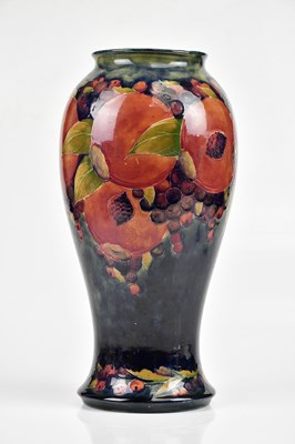 Lot 64 - WILLIAM MOORCROFT; a large vase of inverted...