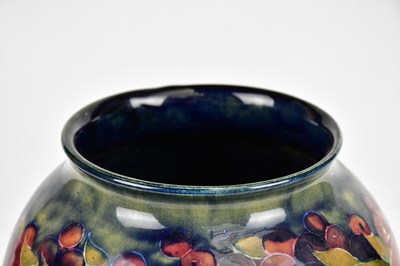 Lot 64 - WILLIAM MOORCROFT; a large vase of inverted...
