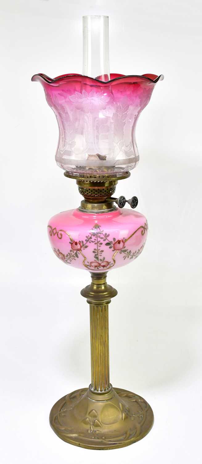 Lot 2334 - A late 19th century oil lamp with cranberry