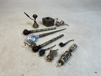 Lot 240 - A group of metal stemmed pipes, one with...