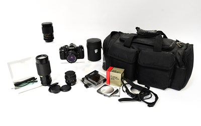 Lot 463 - CANON; a cased A1 SLR camera outfit to include...