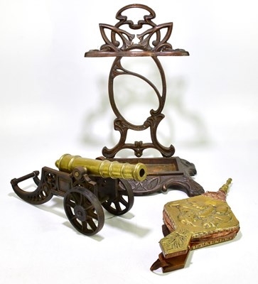Lot 2069 - A cast iron stick stand, together with a brass...