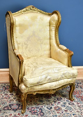 Lot 2415 - A Louis XV style gilt wing back armchair.