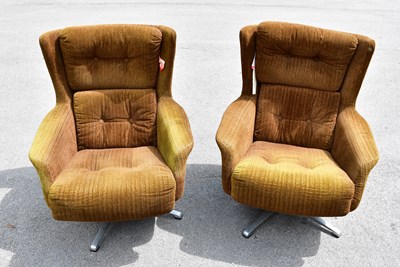 Lot 2533 - A pair of 1970s green upholstered swivel wing...