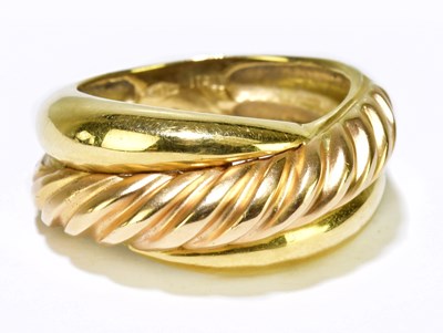 Lot 55 - An 18ct yellow gold ring with textured ribbed...