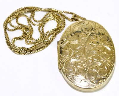 Lot 244 - A 9ct yellow gold floral engraved oval locket...